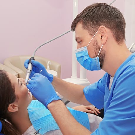 Dentist filling a patient’s cavity