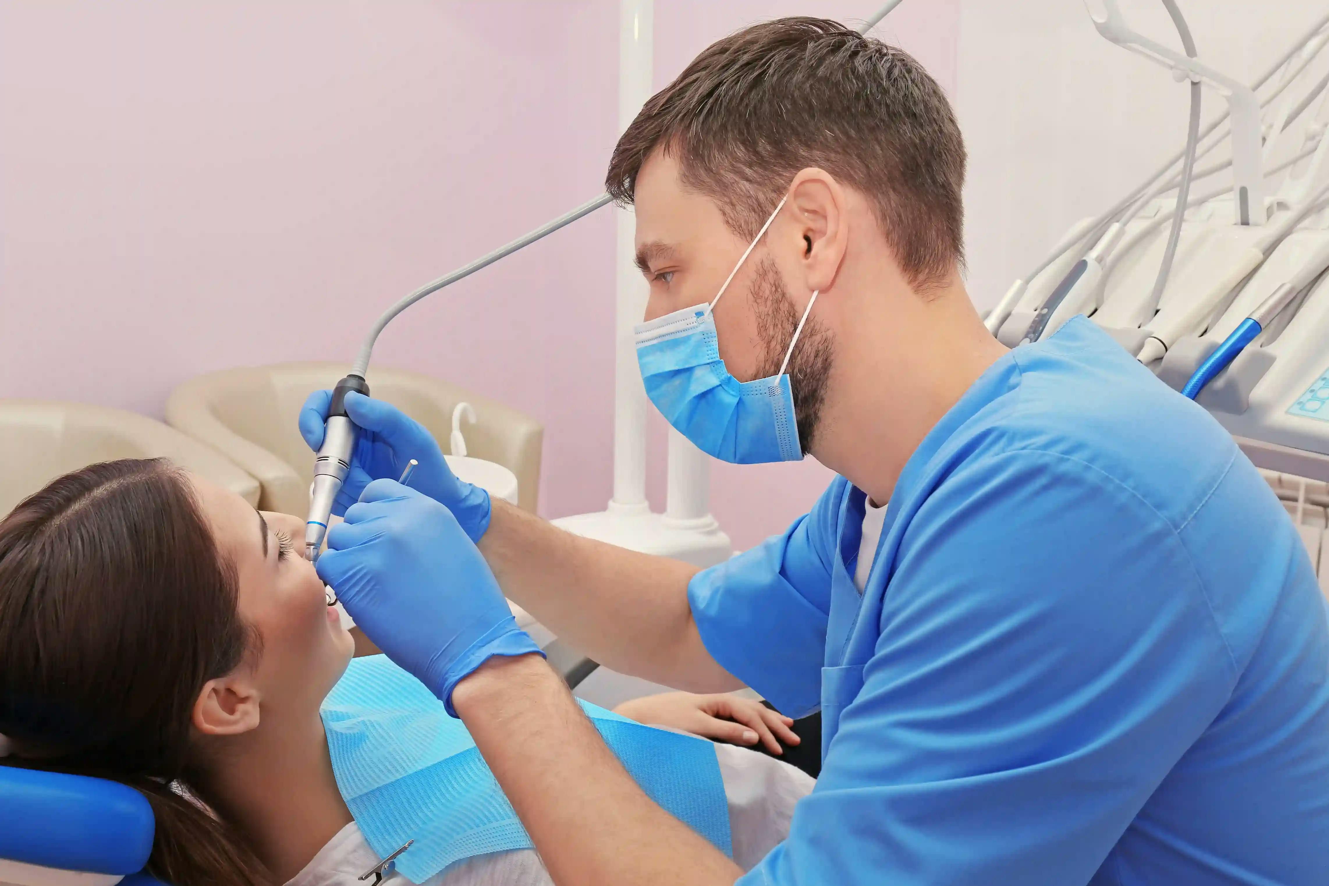 Dentist filling a patient’s cavity