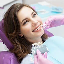 woman in dentist office receiving teeth whitening procedure