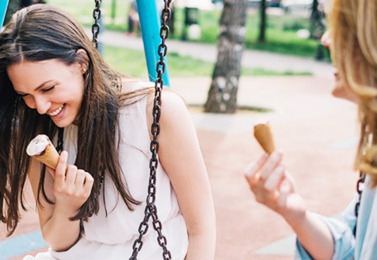 Women with sensitive teeth eating ice cream