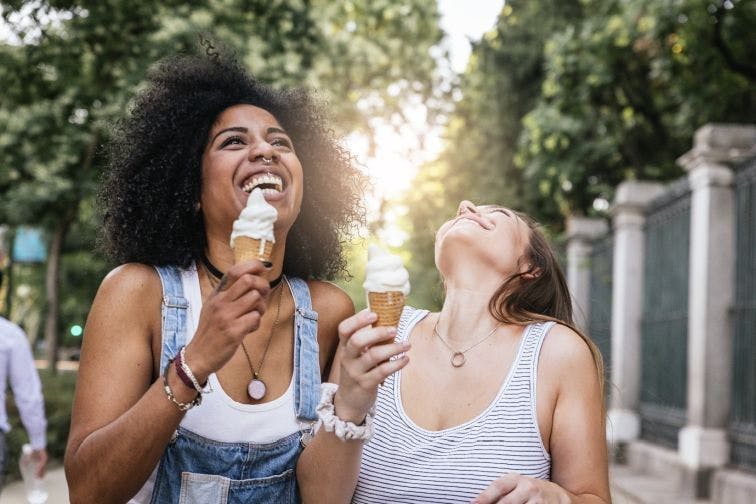 Women with sensitive teeth eating ice cream