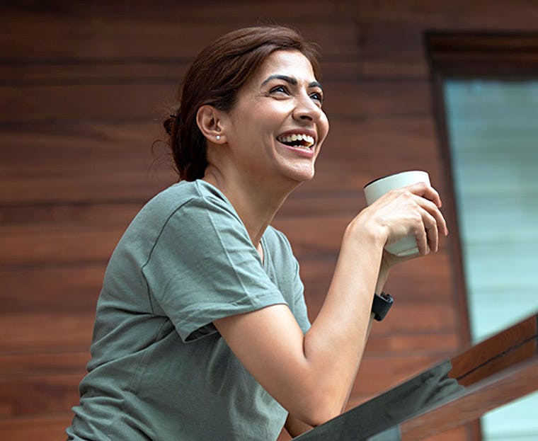 Woman smiling because she just finished whitening her sensitive teeth