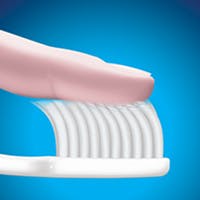 Finger brushing a toothbrush