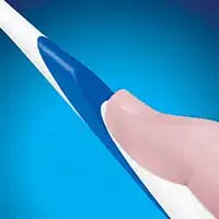Hand gripping a toothbrush