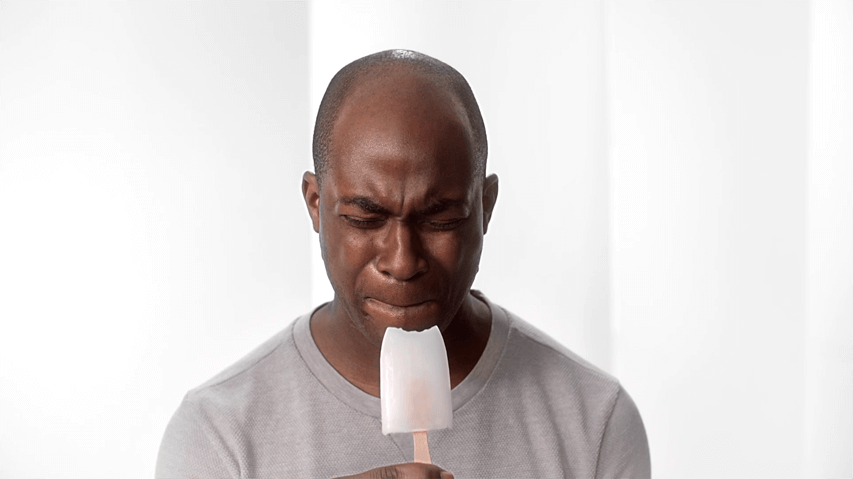 Man biting on ice with sensitive teeth