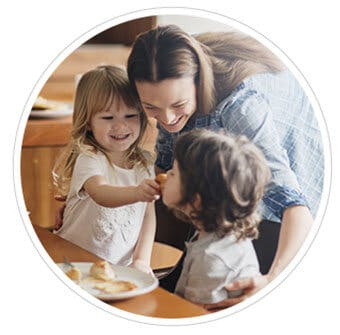 Woman and two small chidren smiling