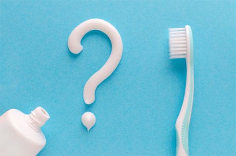 Woman smiling while brushing teeth