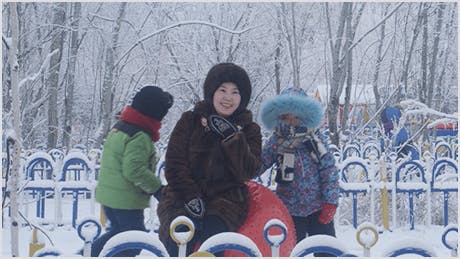 Woman laughing in the winter snow