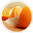 Fresh orange being sliced in half with a knife
