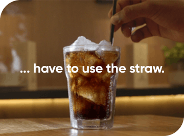Soft drink, ice and a straw