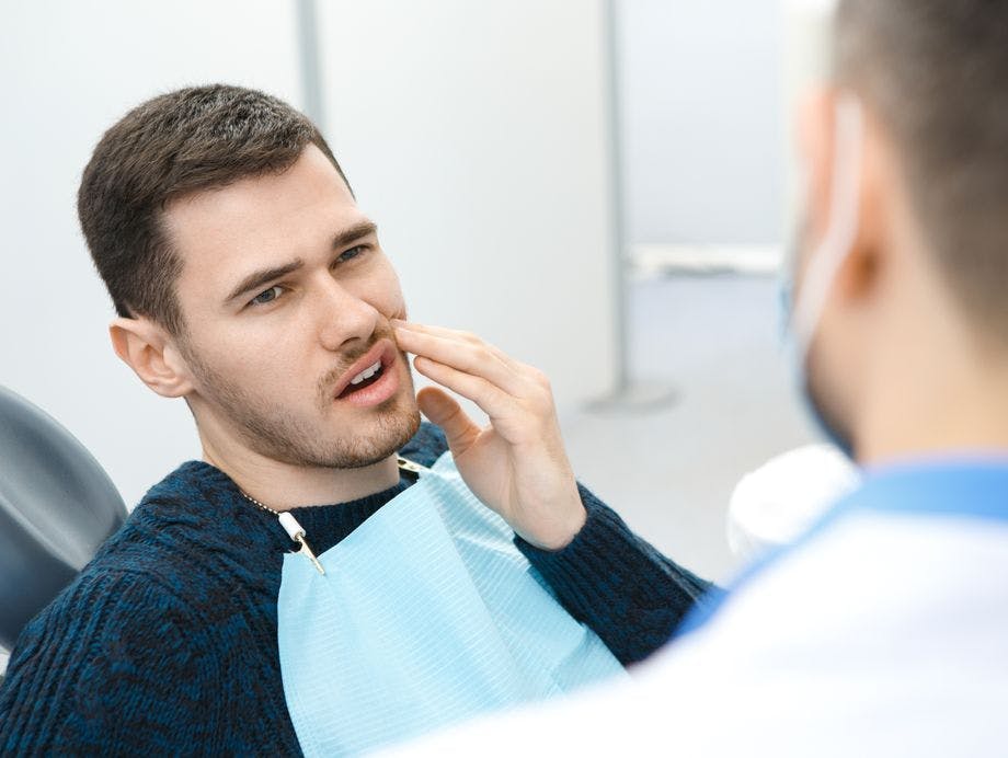 Young man at the dentist has a toothache Young man at the dentist has a toothache
