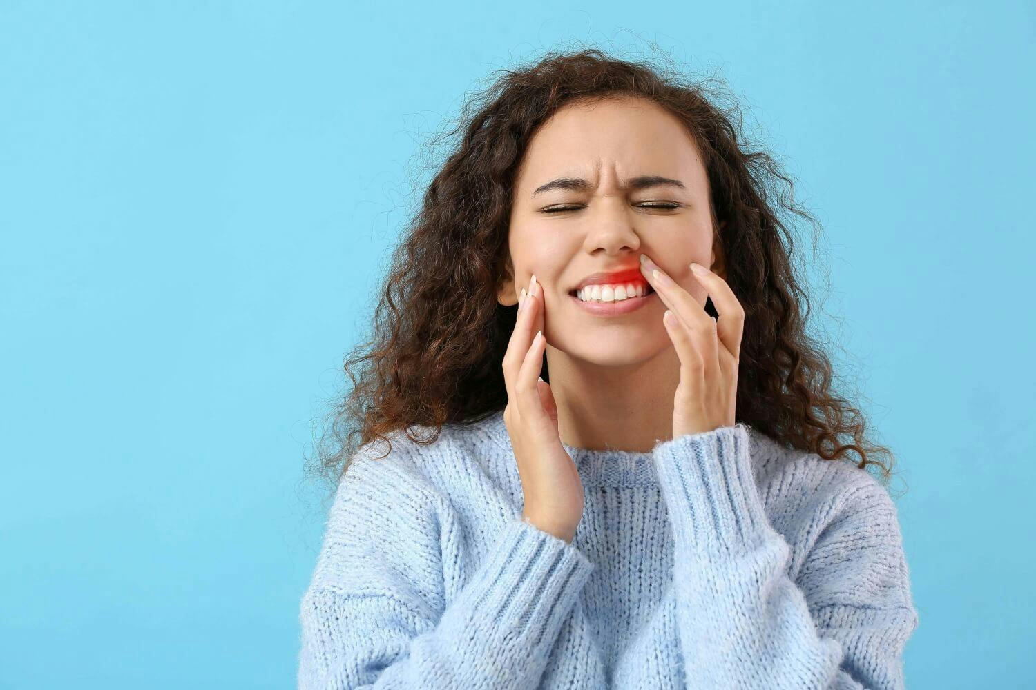 Young African American woman suffering from gum disease Young African American woman suffering from gum disease