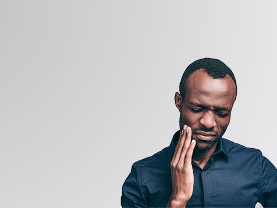 Young man holding his jaw from tooth pain. Young man holding his jaw from tooth pain.