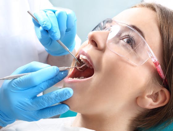 Woman in the dentist's chair during a dental procedure. Woman in the dentist's chair during a dental procedure.