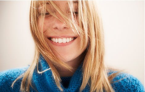 Young blonde woman smiling with closed eyes Young blonde woman smiling with closed eyes