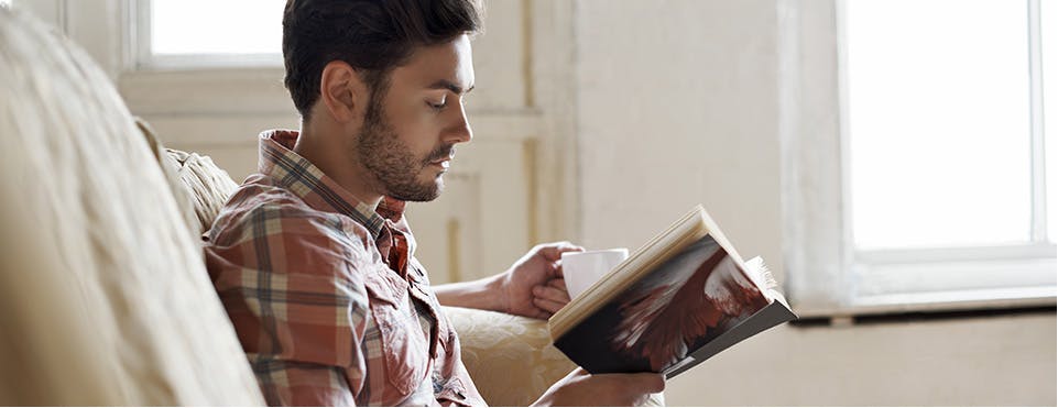 Young man reading a book