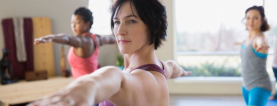 Three women practicing yoga