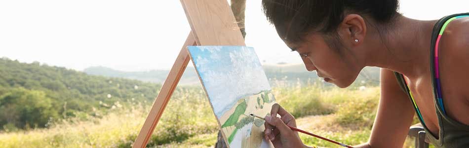 Woman drawing a picture of the surrounding nature