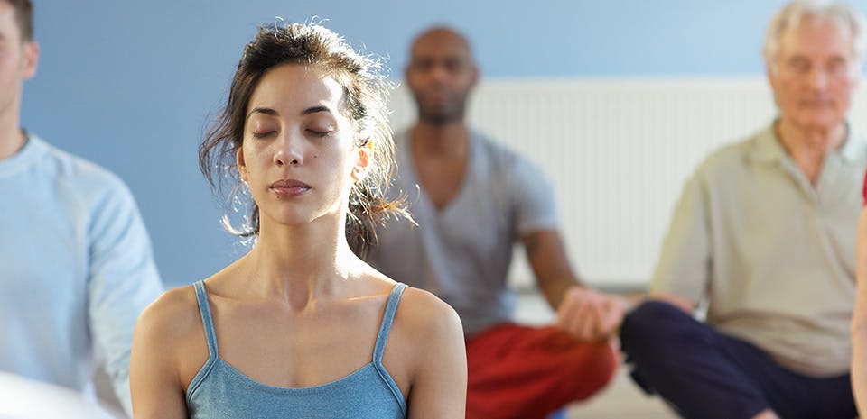 Woman meditating in a group | Make time for yourself