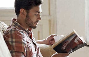 Young man reading a book