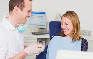 Dentist professional and a woman smiling and talking
