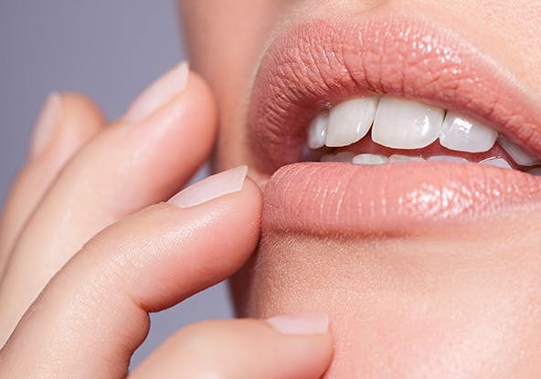 Woman touching her chin and lips