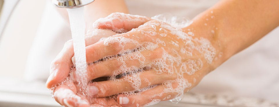 Washing hands under a faucet