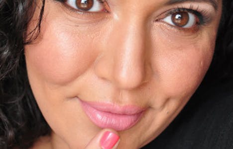 Woman smiling and touching her lip with finger Woman smiling and touching her lip with finger