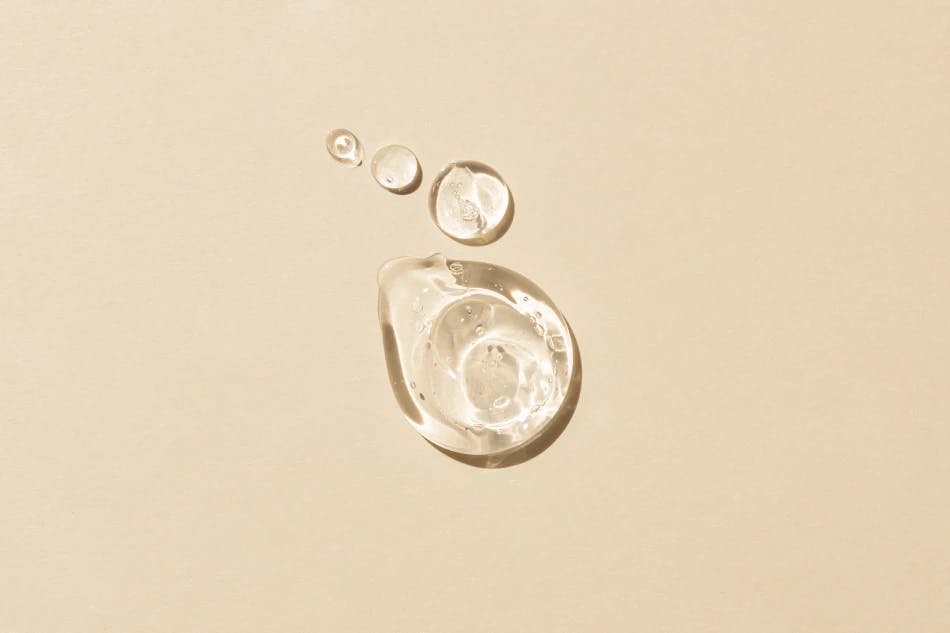 Drops of glycerin with beige background