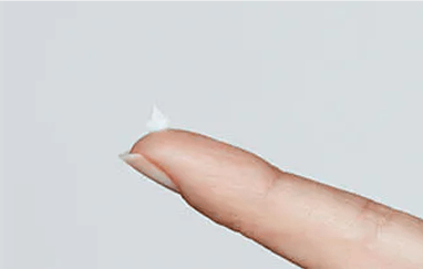 Abreva cream on fingertip for application