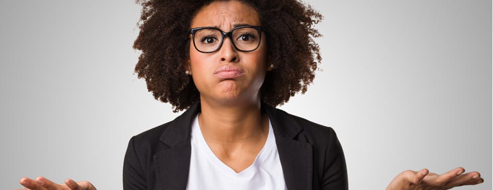 black woman in jacket and glasses looking confused black woman in jacket and glasses looking confused