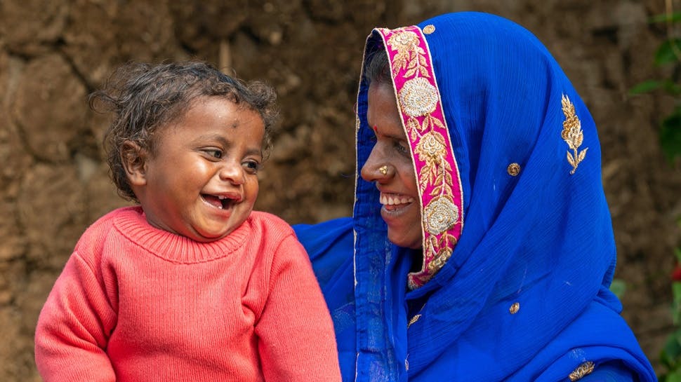 A woman and a baby smiling