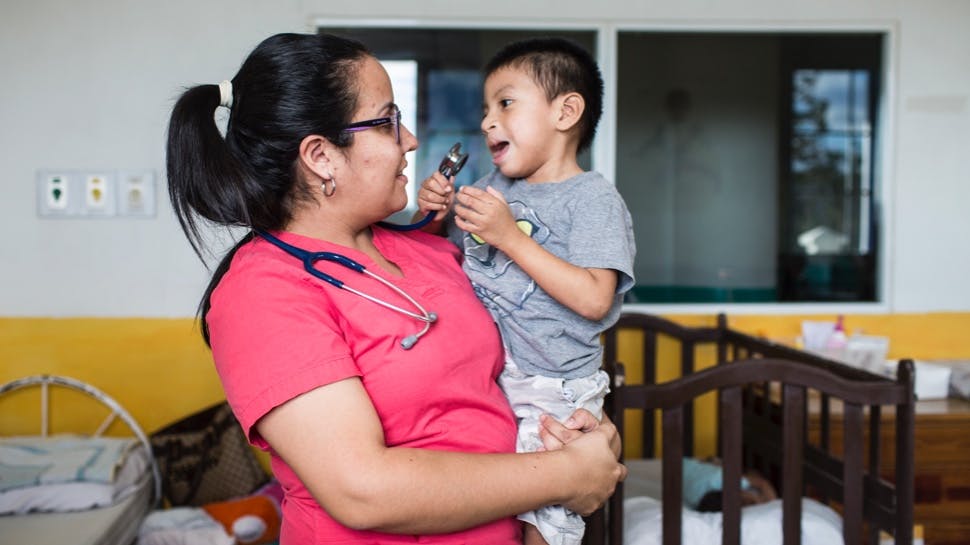 A doctor holding a baby