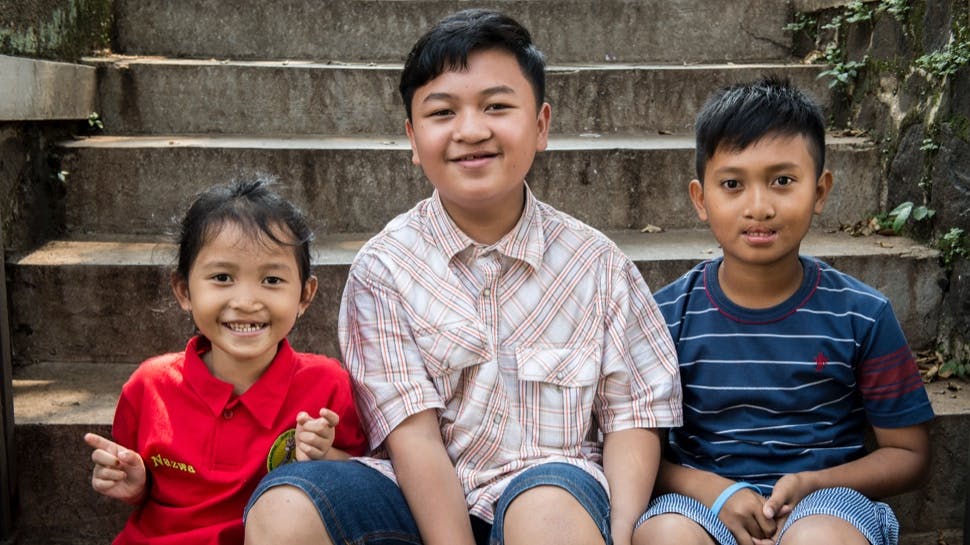 Three children post cleft surgery, smiling