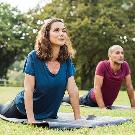 man and woman doing yoga