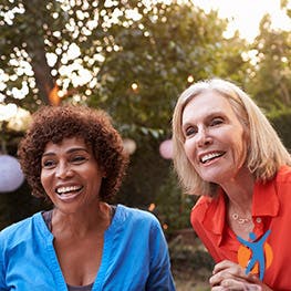 three women smiling outside