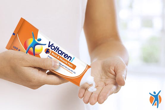 Person squeezing Voltaren pain relief gel into their hand