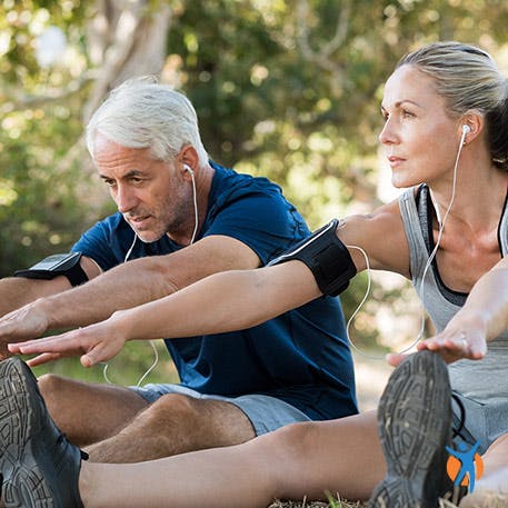 208005778 A man and women stretching their backs in the garden