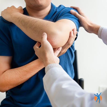Man with a medical professional moving his shoulder
