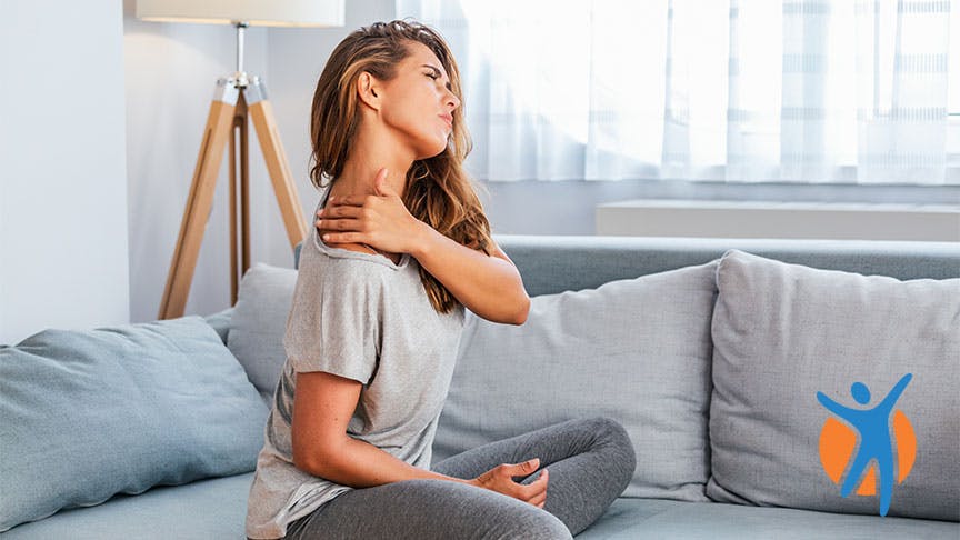 Woman holding her neck and shoulder in pain Woman holding her neck and shoulder in pain