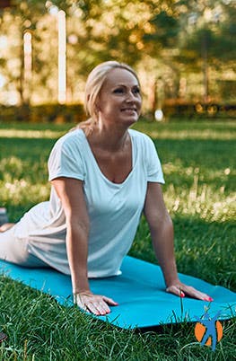 Woman doing yoga and stretching her back