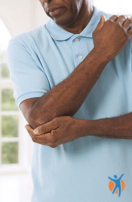 A man holding his elbow in pain