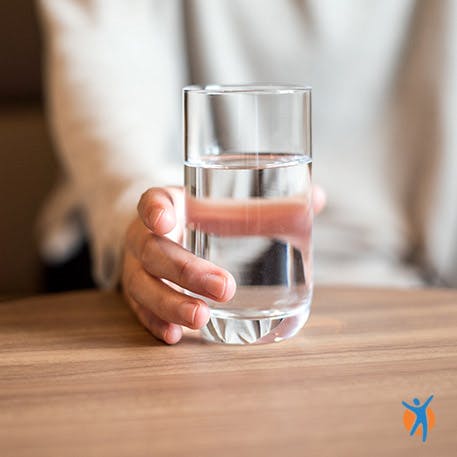 Someone drinking water - learn healthy weight management tips