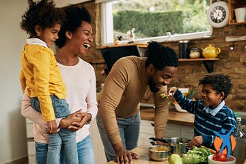 Being with family Healthy young familypreparing lunch - losing weight can ease arthritis pain