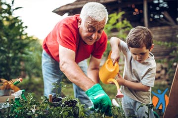 Elderly man with grandson in garden - keeping fit helps reduce weight your knee joints