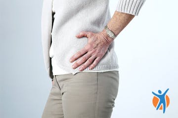 Woman holding her hip in pain - reduce inflammation and osteoarthritis through better diet
