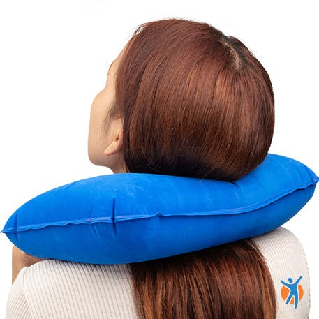Woman using a neck pillow to support her neck