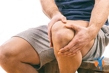 A man in shorts with neuropathic pain in the knee