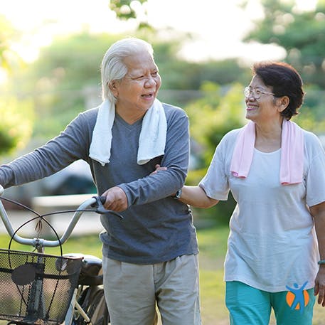 Staying active with exercise Older active couple walking outside - an effective home remedy for osteoarthritis