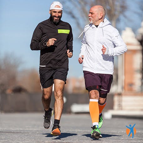 Two men running outside to keep fit - learn weight management tips